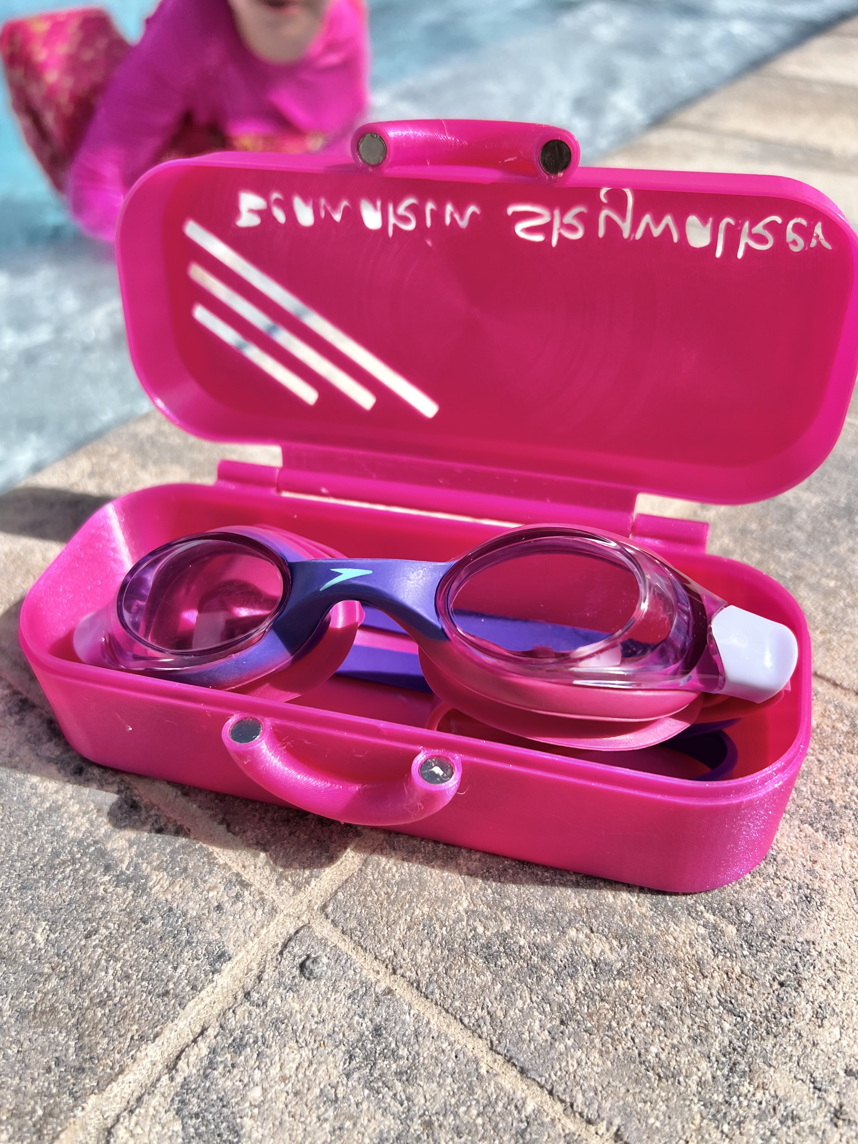 Image of My daughter requested a "custom" goggle holder... with next to zero cad ability, it was off to MakerWorld, where I found: https://makerworld.com/en/models/1980796-swimming-goggles-holder#profileId-2130683
I opted to print in TPU, just for the hope it would stand up to the weather, and a six year old who takes after her dad (clumsy). I added some magnets to keep it locked (since it was now in TPU). It turned out great, and my daughter loved it. Thanks to Vincent @white1073 for the model upload. The smooth plate with a design on it, really made the Pixie Dust TPU pop... Special thank you to Megan at Cookiecad. Amazingly fast customer service and so helpful!