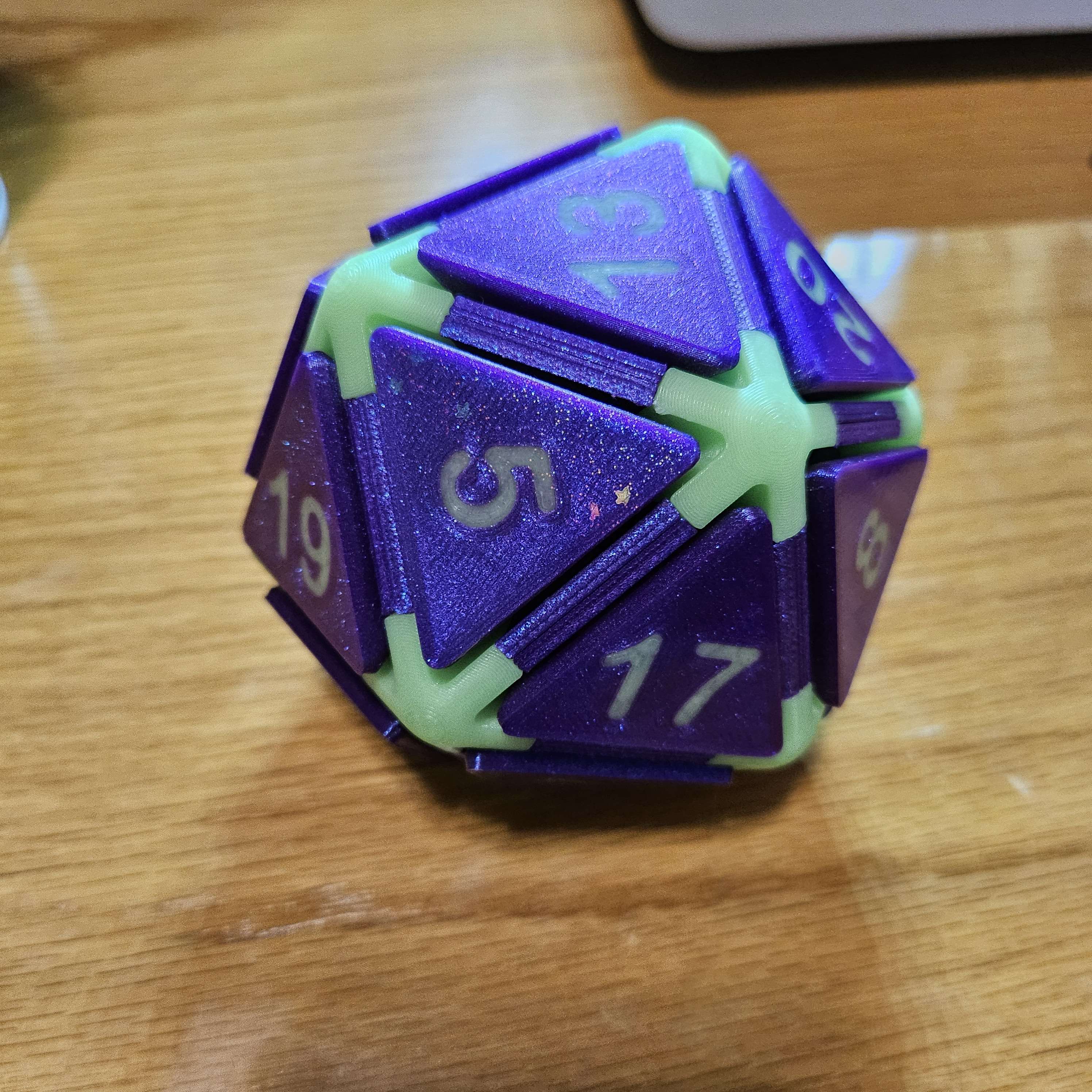 Image of D20 Featuring base of Witches Blue, accents of Green Elixir and the numbering in Funfetti